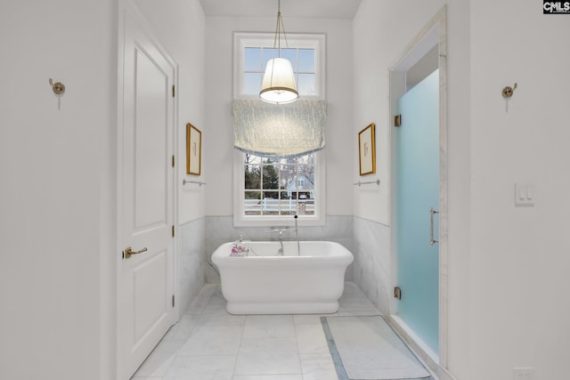 536 Yachting Rd, Lexington, SC 29072 - bathroom featuring tile walls, a wainscoted wall, and a freestanding bath