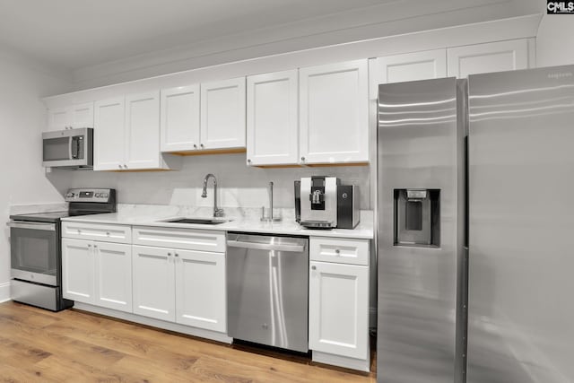 536 Yachting Rd, Lexington, SC 29072 - kitchen featuring light wood-type flooring, light countertops, stainless steel appliances, white cabinetry, and a sink