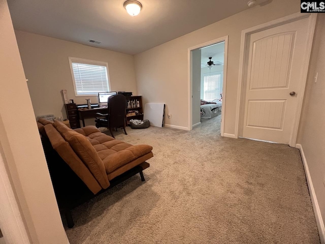 carpeted home office with visible vents and baseboards