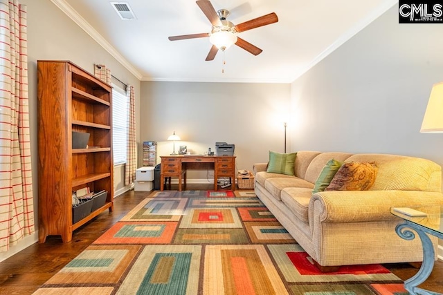 living room featuring crown molding, dark wood-style floors, visible vents, and ceiling fan