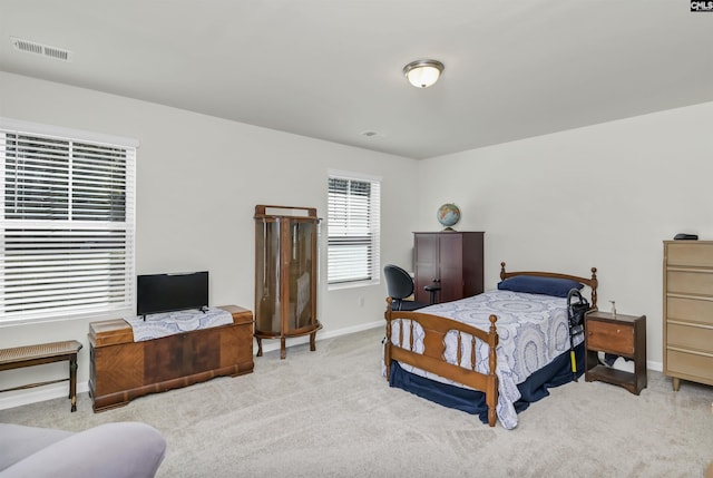 bedroom featuring baseboards, visible vents, and carpet floors