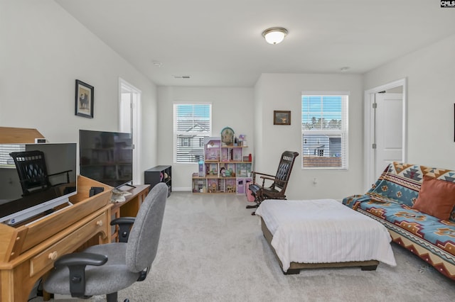 carpeted office space featuring visible vents and baseboards
