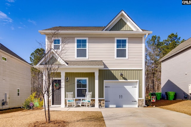 view of front of property with board and batten siding, a porch, concrete driveway, stone siding, and an attached garage