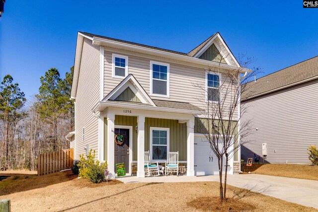 view of front facade featuring a porch, fence, board and batten siding, concrete driveway, and an attached garage