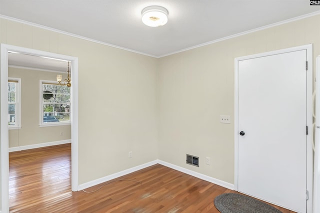 1632 Romain Dr, Columbia, SC 29210 - empty room with visible vents, wood finished floors, crown molding, and a chandelier
