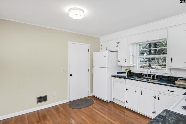 1632 Romain Dr, Columbia, SC 29210 - kitchen featuring white appliances, wood finished floors, visible vents, a sink, and white cabinets