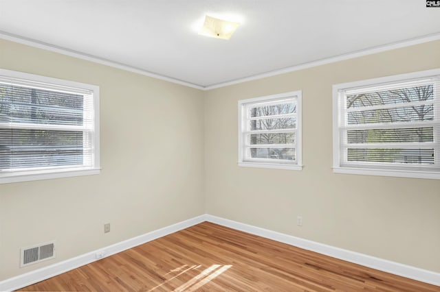 1632 Romain Dr, Columbia, SC 29210 - empty room with light wood-style floors, visible vents, crown molding, and baseboards