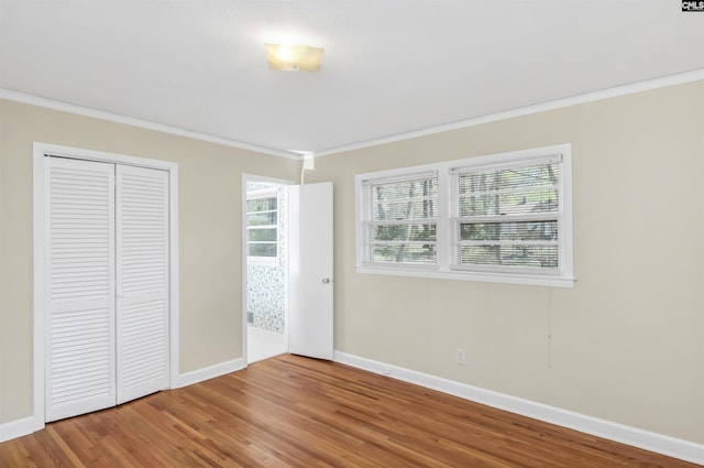 1632 Romain Dr, Columbia, SC 29210 - unfurnished bedroom featuring wood finished floors, baseboards, a closet, and ornamental molding