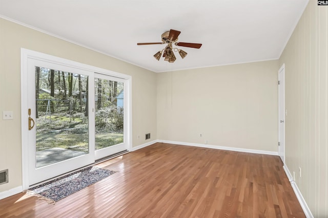1632 Romain Dr, Columbia, SC 29210 - empty room featuring wood finished floors, visible vents, baseboards, ornamental molding, and ceiling fan