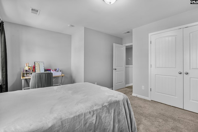 bedroom featuring a closet, visible vents, carpet flooring, and baseboards