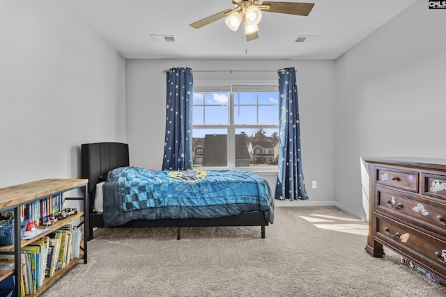 carpeted bedroom featuring visible vents, baseboards, and ceiling fan