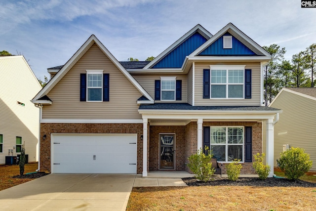craftsman-style house featuring an attached garage, concrete driveway, board and batten siding, central air condition unit, and brick siding
