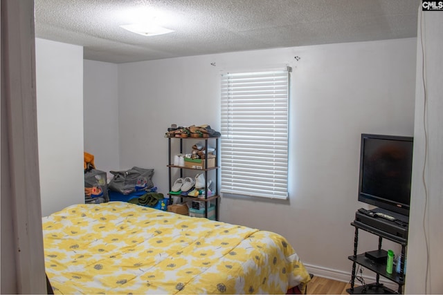 212/210 Nash Rd, Bishopville, SC 29010 - bedroom with a textured ceiling, baseboards, and wood finished floors