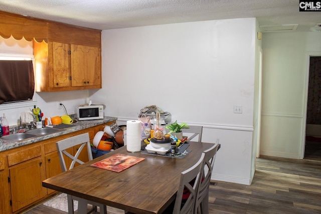 212/210 Nash Rd, Bishopville, SC 29010 - kitchen with white microwave, dark wood-style floors, brown cabinets, and a sink