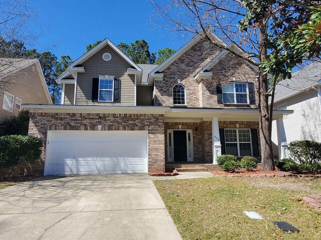 view of front of home with driveway, brick siding, a garage, and a front yard