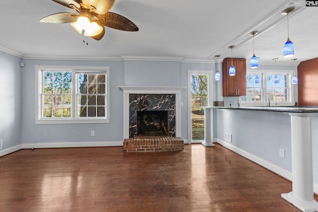 unfurnished living room featuring baseboards, visible vents, crown molding, and wood finished floors