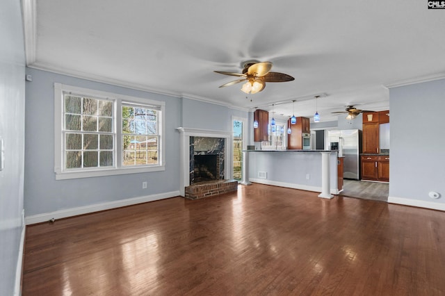 unfurnished living room with a fireplace with raised hearth, crown molding, a ceiling fan, and wood finished floors