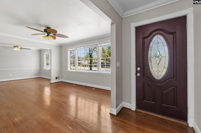 entryway featuring dark wood finished floors, baseboards, visible vents, ceiling fan, and ornamental molding