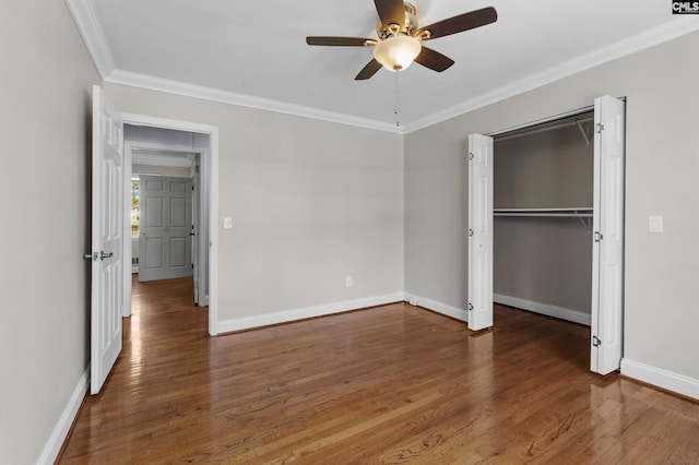 unfurnished bedroom featuring ornamental molding, baseboards, ceiling fan, and wood finished floors