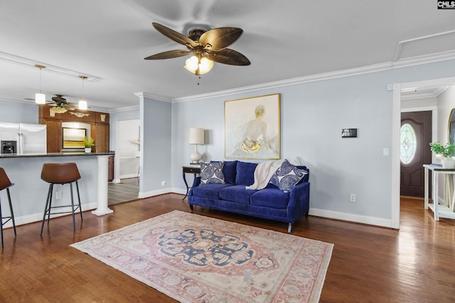 living area with a ceiling fan, crown molding, and dark wood finished floors