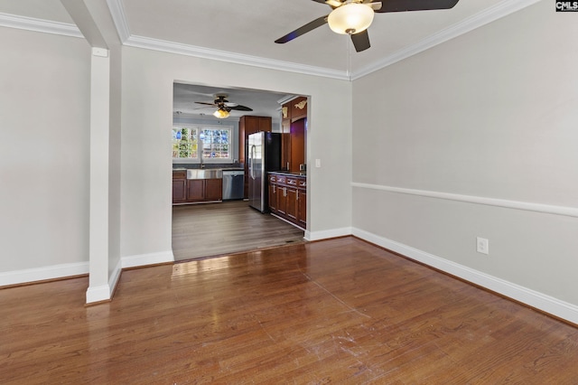 spare room featuring ornamental molding, ceiling fan, and dark wood-type flooring