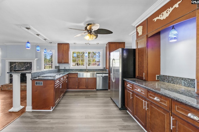 kitchen featuring a sink, a ceiling fan, ornamental molding, and stainless steel appliances