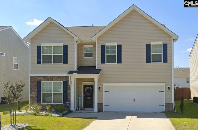 view of front facade with an attached garage, a shingled roof, a front lawn, concrete driveway, and stone siding