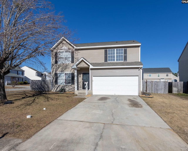 traditional-style house with concrete driveway, a front lawn, fence, and an attached garage