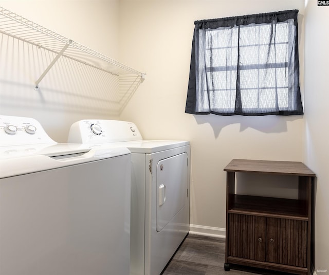 washroom featuring baseboards, separate washer and dryer, laundry area, and dark wood-type flooring