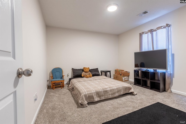 bedroom with baseboards, visible vents, and carpet