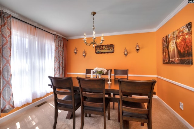 dining room with carpet floors, a chandelier, baseboards, visible vents, and ornamental molding