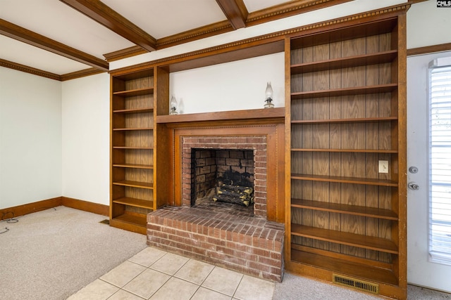 living room with carpet floors, beam ceiling, a brick fireplace, baseboards, and visible vents