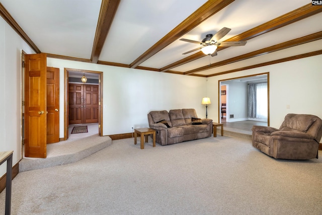 carpeted living area with baseboards, a ceiling fan, crown molding, and beamed ceiling