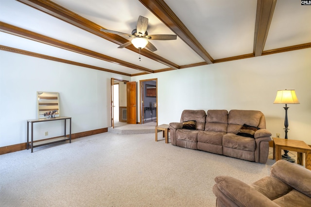 carpeted living room with ornamental molding, beam ceiling, baseboards, and ceiling fan