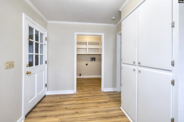 interior space with baseboards, ornamental molding, laundry area, and light wood-type flooring