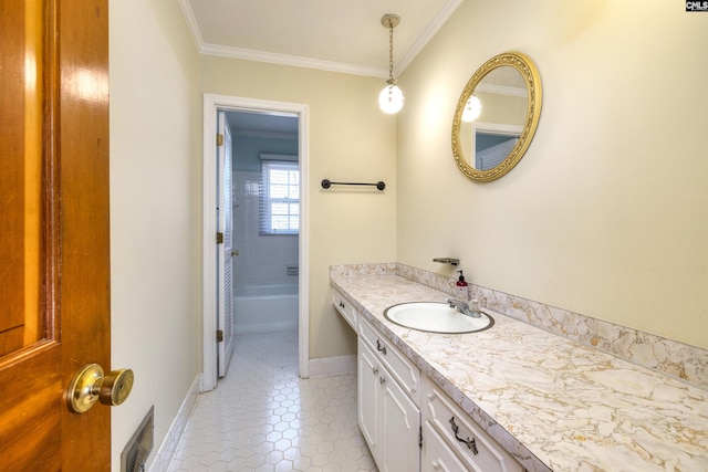 full bathroom with tile patterned flooring, vanity, crown molding, baseboards, and a bathtub