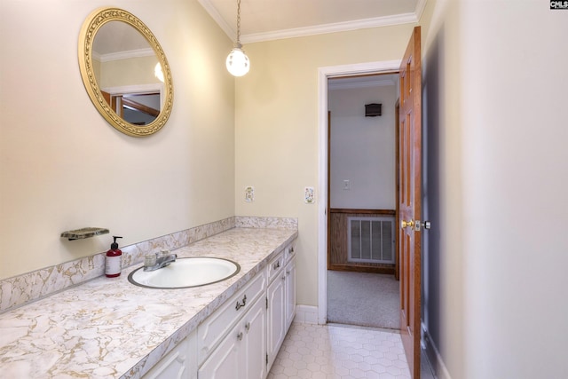 bathroom featuring tile patterned flooring, vanity, ornamental molding, baseboards, and visible vents