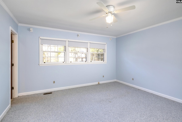 empty room featuring plenty of natural light, crown molding, and carpet floors