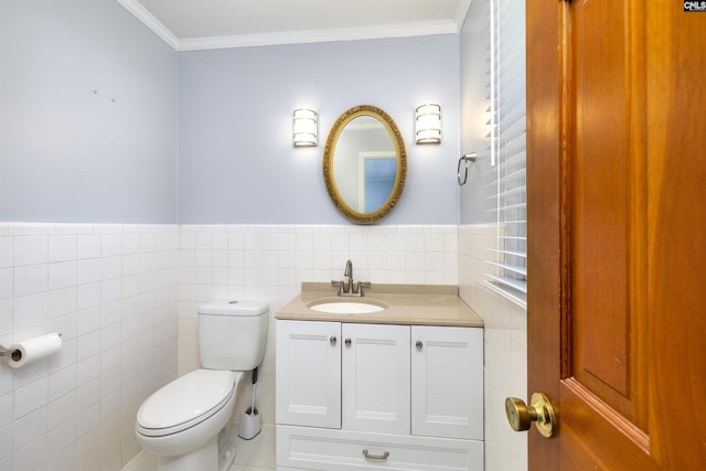 bathroom with tile walls, ornamental molding, toilet, and vanity