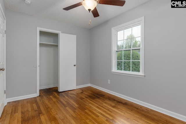 4104 Candlelite Dr, Columbia, SC 29209 - unfurnished bedroom with a closet, hardwood / wood-style flooring, a ceiling fan, a textured ceiling, and baseboards