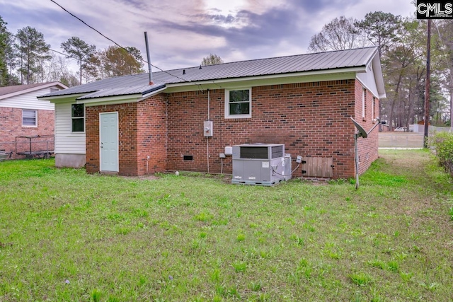 4104 Candlelite Dr, Columbia, SC 29209 - back of house with fence, central air condition unit, a yard, and metal roof