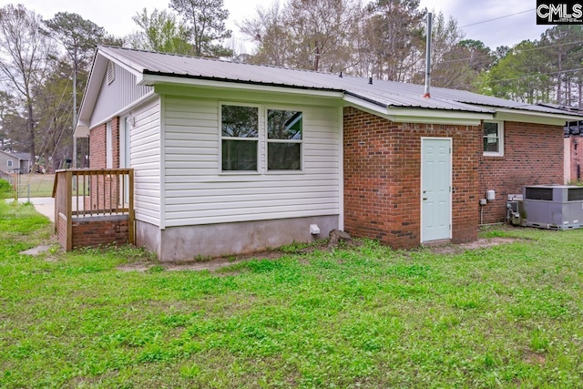 4104 Candlelite Dr, Columbia, SC 29209 - rear view of property with cooling unit, brick siding, a lawn, and metal roof