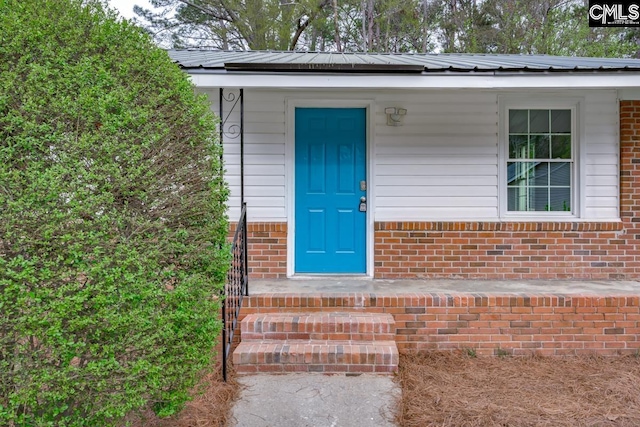 4104 Candlelite Dr, Columbia, SC 29209 - view of exterior entry with metal roof and brick siding