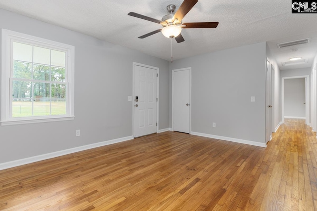 4104 Candlelite Dr, Columbia, SC 29209 - spare room with a textured ceiling, visible vents, light wood finished floors, baseboards, and a ceiling fan