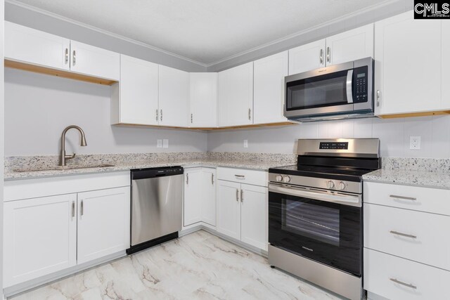 4104 Candlelite Dr, Columbia, SC 29209 - kitchen featuring white cabinetry, ornamental molding, stainless steel appliances, a sink, and light stone counters