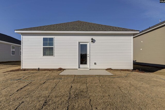 130 Shumard Ct, Columbia, SC 29203 - back of property featuring a shingled roof and a patio