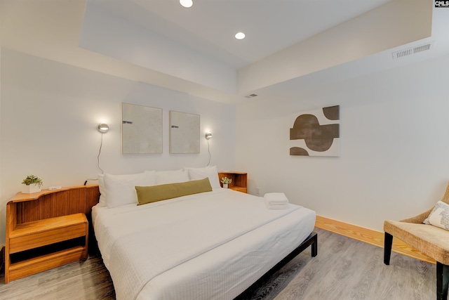 bedroom featuring wood finished floors, recessed lighting, baseboards, and visible vents