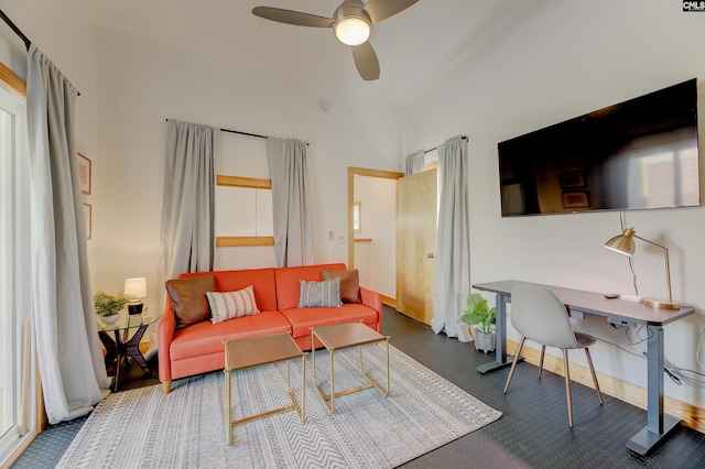 living room featuring baseboards, lofted ceiling, and ceiling fan