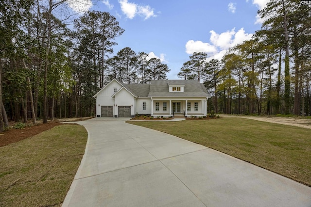 view of front facade featuring a front yard, covered porch, and concrete driveway