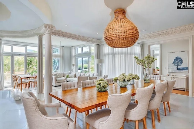 dining area featuring ornamental molding and ornate columns